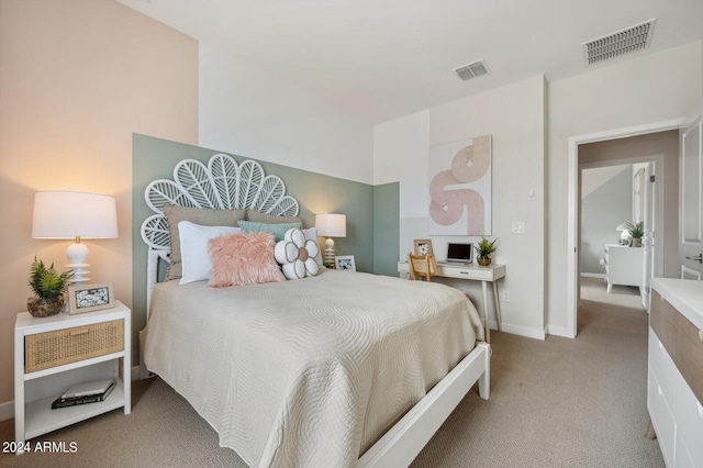 bedroom featuring light colored carpet, visible vents, and baseboards