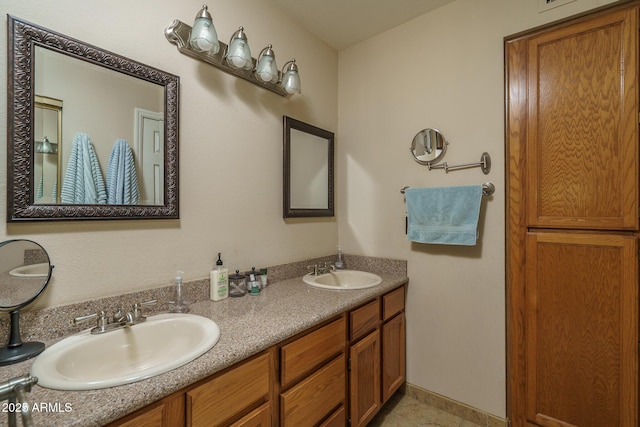 full bathroom featuring tile patterned flooring, a sink, and double vanity