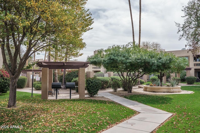 view of property's community with a patio area and a yard