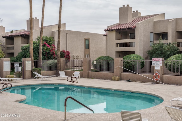 view of pool featuring a patio and fence