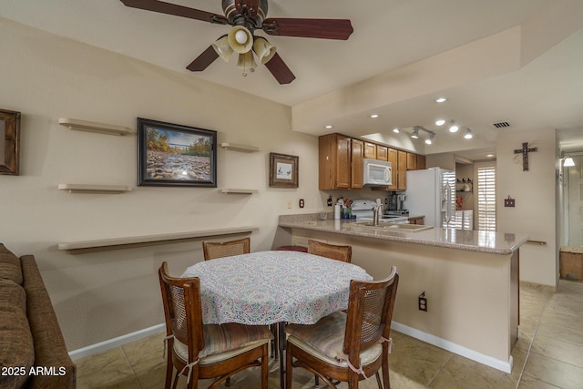 dining space with light tile patterned floors, baseboards, and visible vents