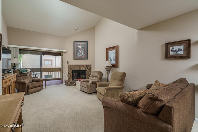 carpeted living room featuring lofted ceiling and a stone fireplace