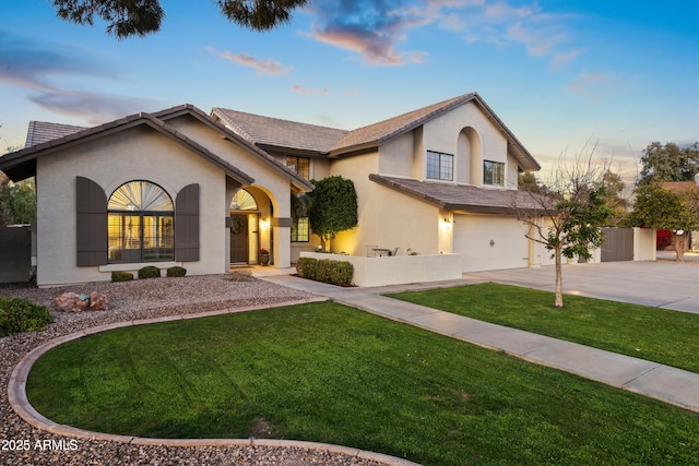 view of front of home featuring a garage and a yard