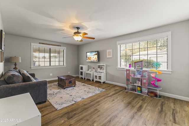 living room featuring dark hardwood / wood-style floors and ceiling fan