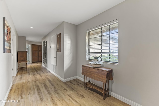 corridor with light hardwood / wood-style floors