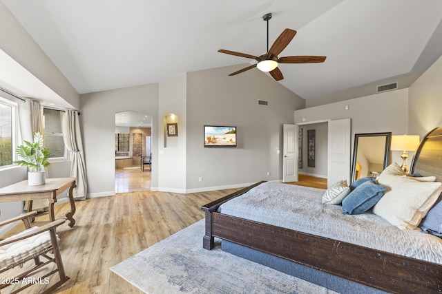 bedroom with ceiling fan, high vaulted ceiling, and light hardwood / wood-style flooring