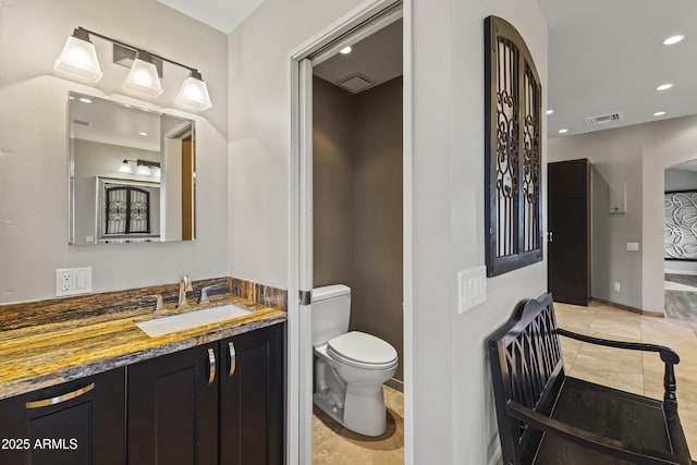 bathroom with vanity, toilet, and tile patterned flooring