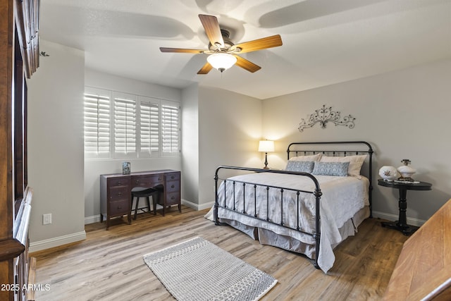 bedroom with hardwood / wood-style floors and ceiling fan