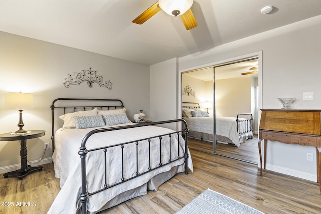 bedroom with hardwood / wood-style flooring, ceiling fan, and a closet