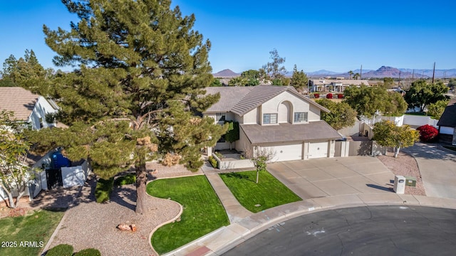 view of front of house featuring a mountain view, a garage, and a front yard