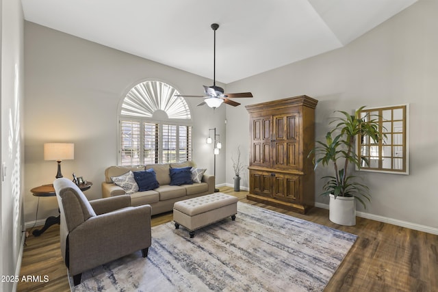 living room with ceiling fan, dark hardwood / wood-style flooring, and vaulted ceiling