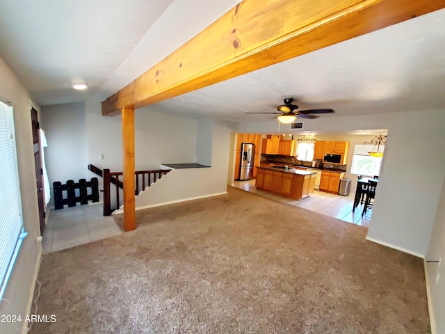 unfurnished living room featuring ceiling fan and light tile patterned floors