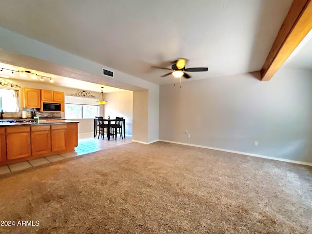 tiled living room with beamed ceiling, rail lighting, and ceiling fan