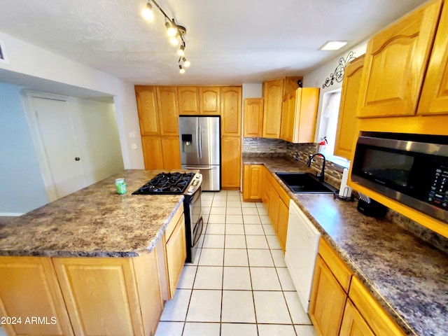 kitchen with light tile patterned flooring, tasteful backsplash, a center island, appliances with stainless steel finishes, and sink