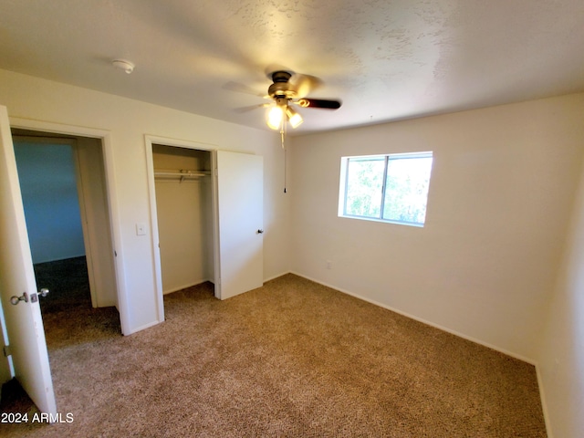 unfurnished bedroom with a closet, carpet floors, and ceiling fan