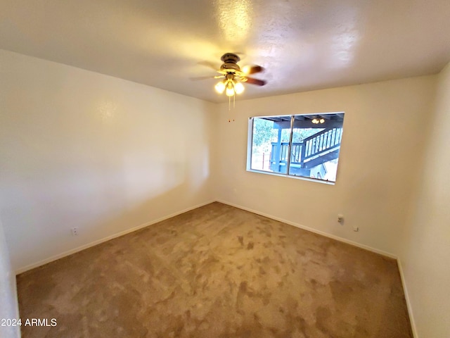 carpeted empty room with ceiling fan