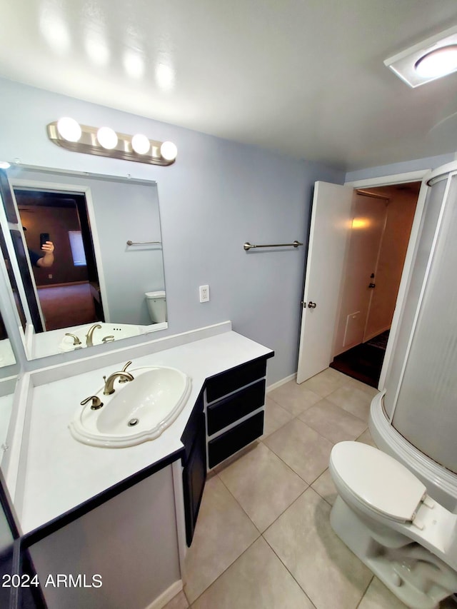 bathroom with vanity, tile patterned floors, and toilet