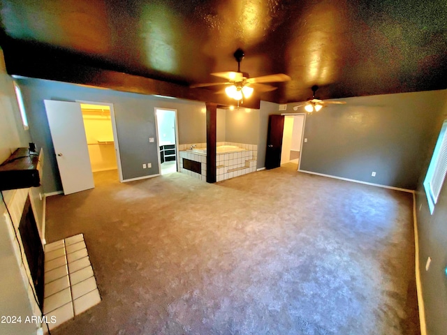 carpeted cinema room with ceiling fan