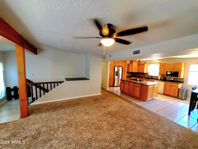 kitchen featuring beamed ceiling, light tile patterned floors, stainless steel fridge with ice dispenser, dishwasher, and ceiling fan