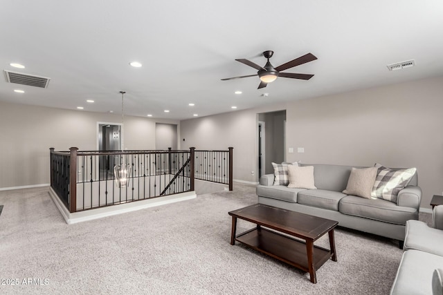 carpeted living room featuring baseboards, ceiling fan, visible vents, and recessed lighting