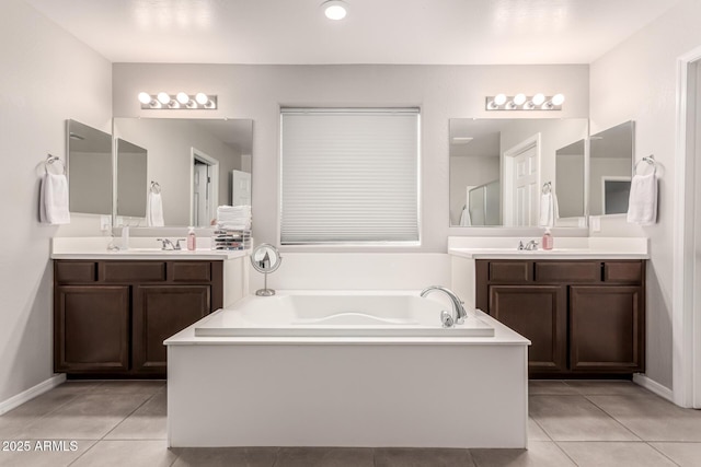 bathroom with tile patterned flooring, two vanities, a sink, and a bath