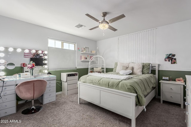 carpeted bedroom with visible vents and a ceiling fan