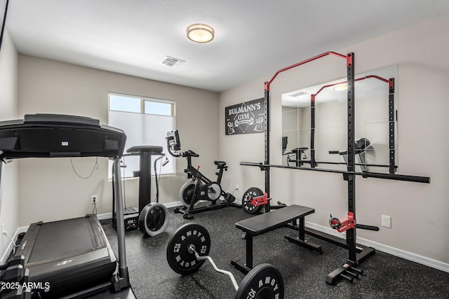 exercise area featuring visible vents and baseboards