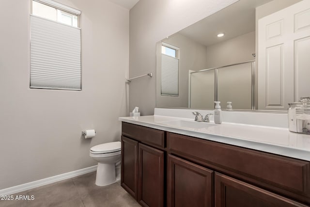 bathroom with baseboards, toilet, tile patterned flooring, vanity, and a shower stall