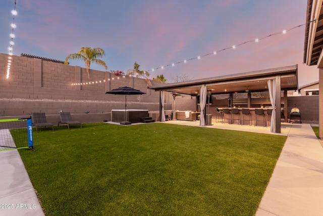 view of yard with a fenced backyard, an outdoor hangout area, outdoor dry bar, a patio area, and central AC