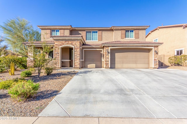 view of front of home featuring a tile roof, stucco siding, concrete driveway, an attached garage, and stone siding