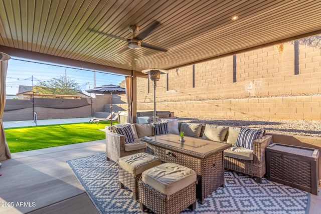 view of patio with outdoor lounge area, fence, and a ceiling fan