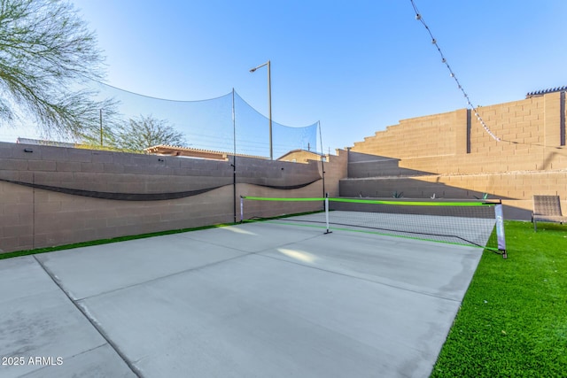 surrounding community featuring a tennis court and a fenced backyard