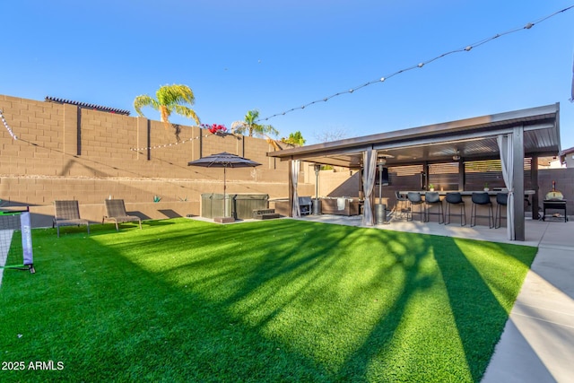 view of yard with a fenced backyard, outdoor dry bar, and a patio