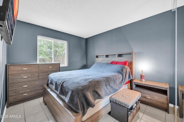 tiled bedroom with a textured ceiling