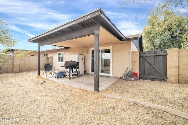 back of property with a patio