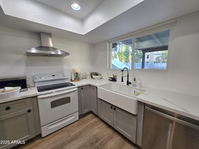 3722 E Glade Ave, Mesa, AZ 85206 - kitchen featuring electric stove, wall chimney exhaust hood, gray cabinets, a sink, and wood finished floors