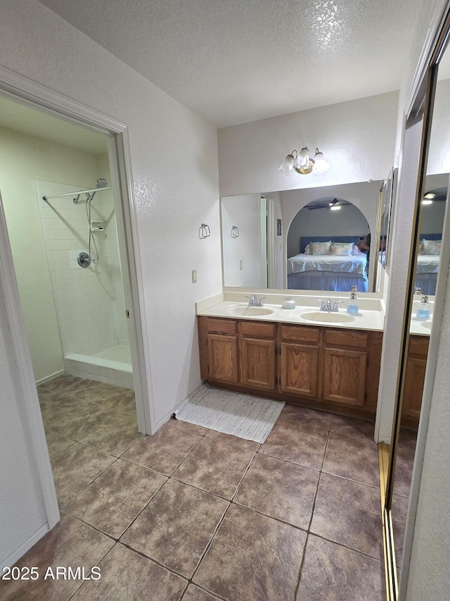 3722 E Glade Ave, Mesa, AZ 85206 - full bathroom with double vanity, ensuite bath, a textured ceiling, a shower stall, and tile patterned floors