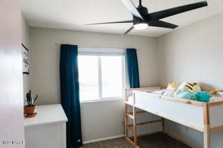 bedroom featuring dark carpet, a ceiling fan, and baseboards