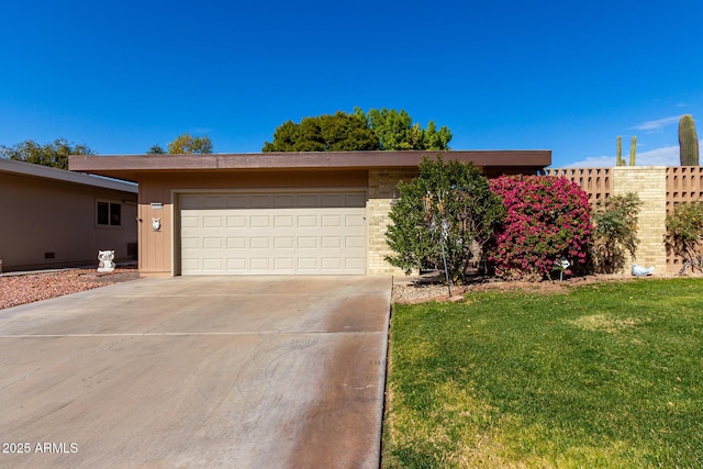 single story home featuring a garage and a front lawn