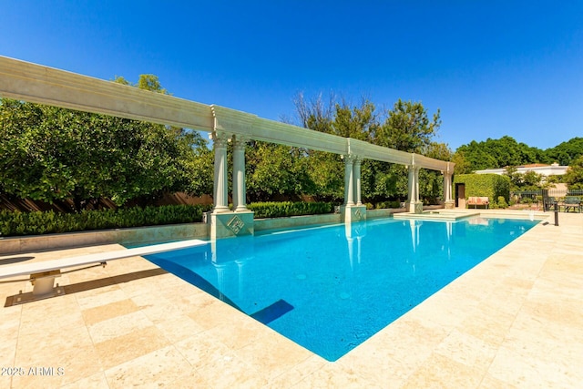 pool with a patio and a diving board