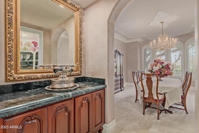 bathroom with a chandelier, crown molding, and vanity