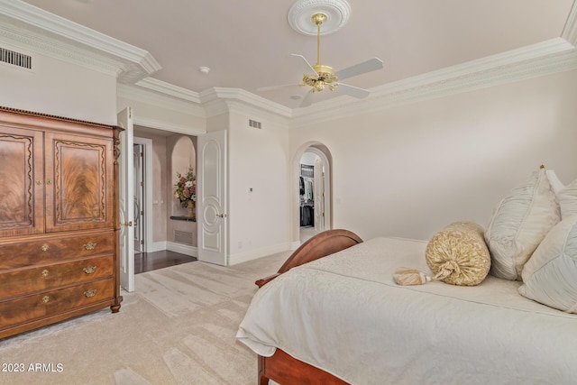 bedroom with arched walkways, visible vents, light carpet, and baseboards