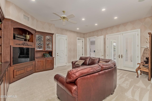 living area with french doors, visible vents, light carpet, and wallpapered walls