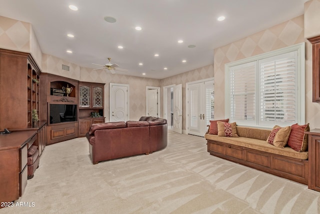 living area featuring light carpet, french doors, recessed lighting, and wallpapered walls