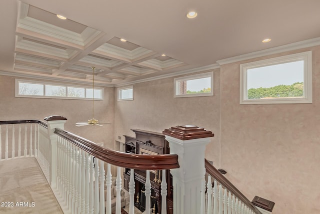 hall with ornamental molding, coffered ceiling, plenty of natural light, and an upstairs landing