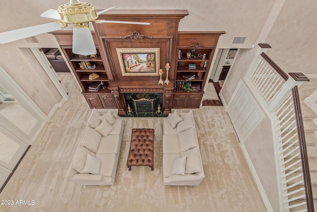 living room featuring stairway, a premium fireplace, and visible vents