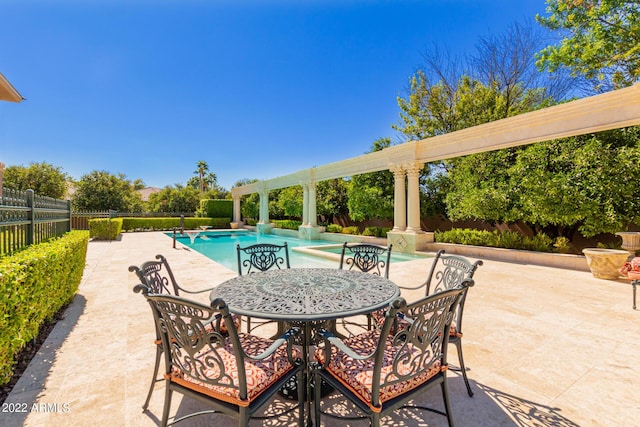 view of swimming pool with a patio, outdoor dining space, fence private yard, and a fenced in pool