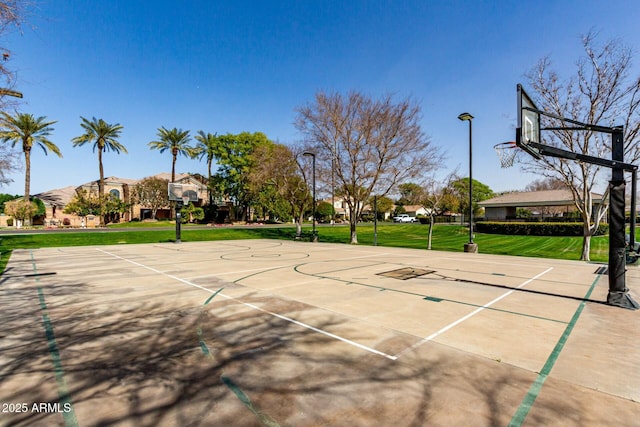 view of basketball court with community basketball court and a lawn