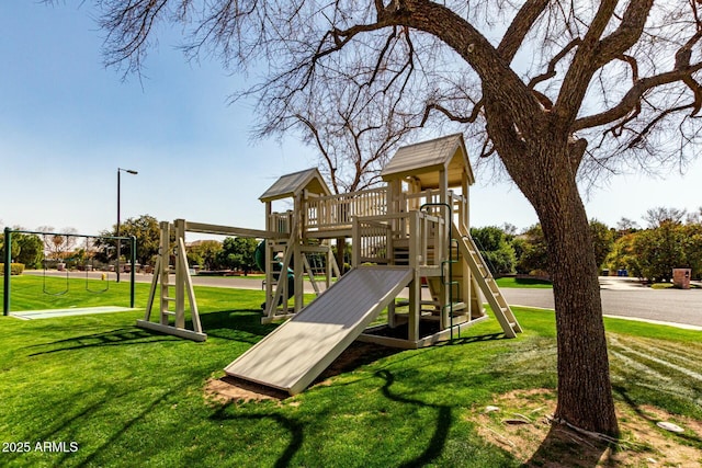 community jungle gym featuring a lawn