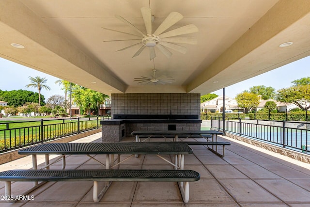 view of patio featuring fence and a ceiling fan